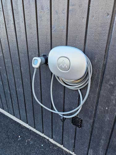 a white cord hooked up to a wall at Attefallshus Nära Havet Norranäs in Varberg