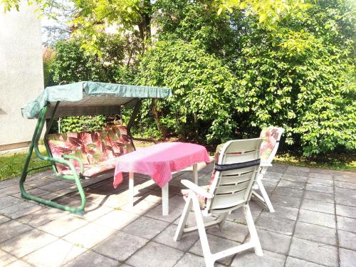 two chairs and a table and a table and chairs at Vila Gardenia in Sarajevo