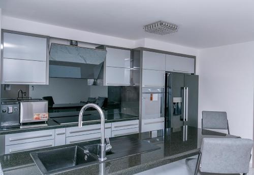 a kitchen with a sink and a refrigerator at Villa Palma Krk in Krk