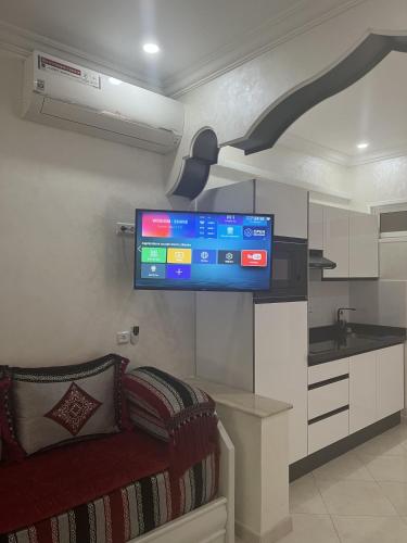 a living room with a flat screen tv on the wall at Royal Rif Alhoceima Centre in Al Hoceïma
