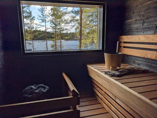 a sauna with a large window in a cabin at Lakehouse Juolas in Mäntyharju