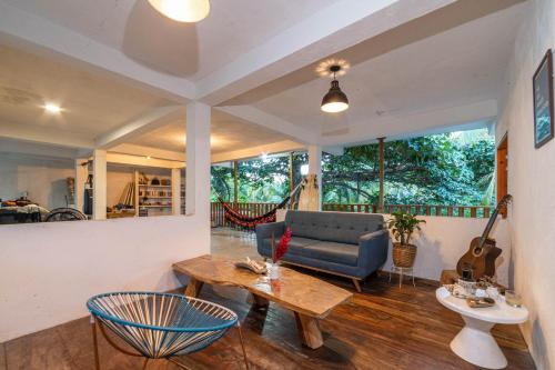 a living room with a couch and a table at Casa Chapolin Boutique Guesthouse in Palomino