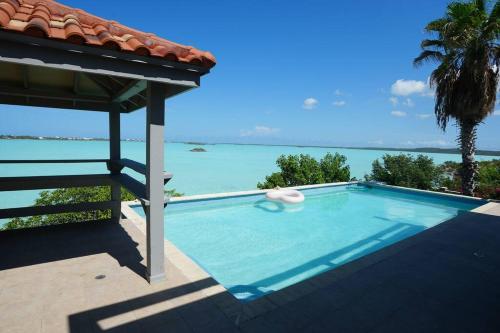 a swimming pool with a view of the ocean at Turquoise Haven Villa in Providenciales
