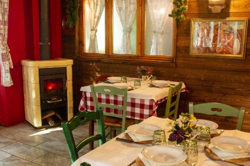 a dining room with tables and chairs and a fireplace at Agriturismo Cà Gabrielli in Lizzano in Belvedere