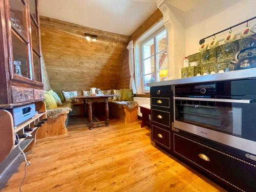a living room with a stove and a table at Weißt Du noch - Gästehäuser & Suiten in Kühlungsborn