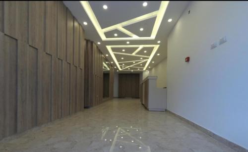 a hallway with wooden walls and a ceiling with lights at Amazing one Bedroom Apartment in Amman Elwebdah 1 in Amman