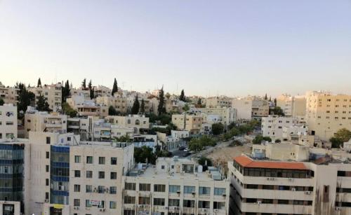 a view of a city with white buildings at Amazing one Bedroom Apartment in Amman Elwebdah 1 in Amman