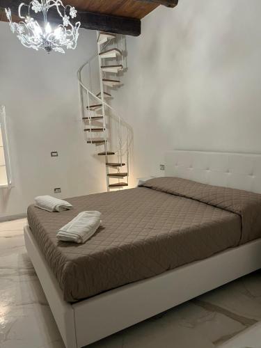 a bedroom with a bed and a spiral staircase at B&B bella vista in Pizzo