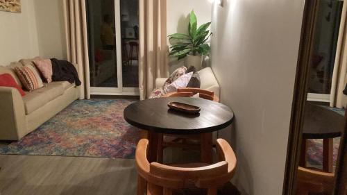 a living room with a table and chairs and a refrigerator at Depto en condo Pucon Andino in Pucón