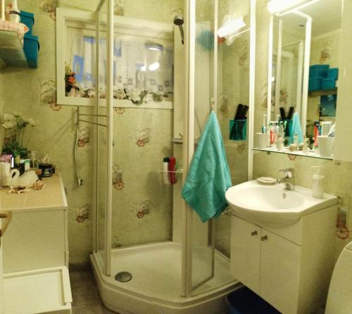 y baño con ducha y lavamanos. en Ett-to rom til leie i et privat hus en Brumunddal