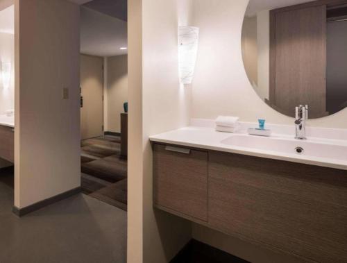 a bathroom with a sink and a mirror at Aloft Scottsdale in Scottsdale