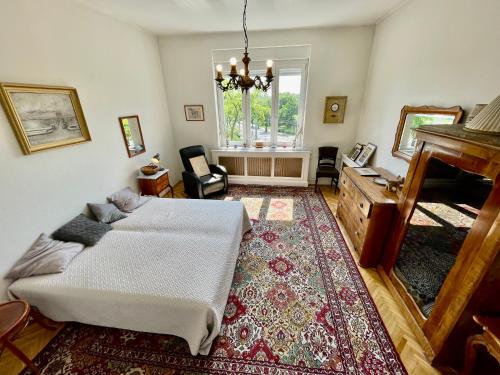 a living room with a bed and a piano at Villa with terrace overlooking the city park in Budapest