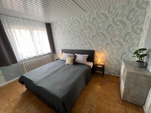 a bedroom with a bed and a wall at Apartments Marienburg in Nordstemmen