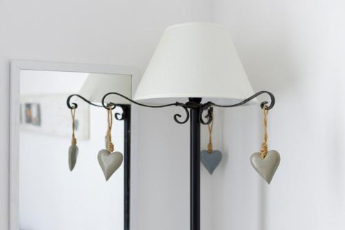 a lamp with hearts hanging on the wall at Sissi's Home [Due Passi Dal Mare, Free WiFi] in Punta Marina
