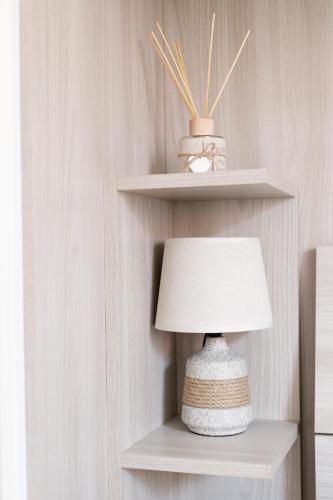 a lamp sitting on a shelf next to a wall at Sissi's Home [Due Passi Dal Mare, Free WiFi] in Punta Marina
