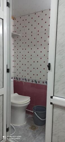 a bathroom with a toilet and a wall with hearts at residhome in Sétif