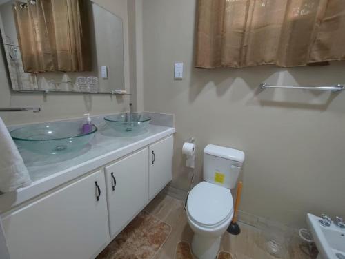 a bathroom with a toilet and a sink at Chez Moi in Castries