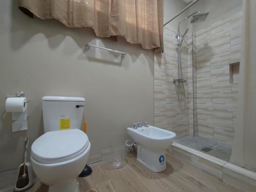 a bathroom with a toilet and a sink and a shower at Chez Moi in Castries