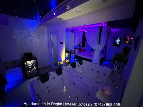 a living room with purple lights and a couch at Apartament cu o camera de Lux cu Jacuzzi/Constelatie complet utilat acceptam plata cu cardul de vacanta in Botoşani