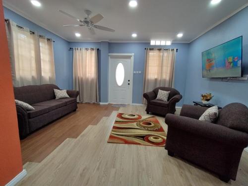 a living room with two couches and a rug at Chez Moi in Castries