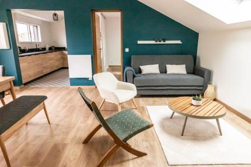 a living room with a couch and a table at La Terrasse du Sentier in Sangatte