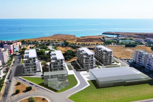 an aerial view of three apartment buildings in front of the ocean at SeaCity Vibes Apartments in Monopoli