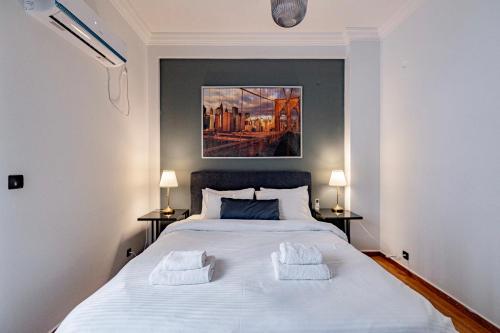 a bedroom with a large white bed with two night stands at Cozy apartment in Kolonaki Athens - Sleeps 5 in Athens