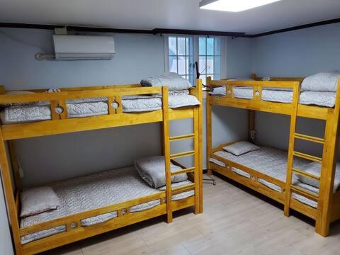 two sets of bunk beds in a room at Yeobyeol Guesthouse in Jeonju