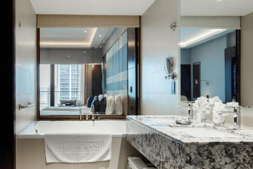 a bathroom with two sinks and a large mirror at Ramee Dream Hotel Downtown in Dubai