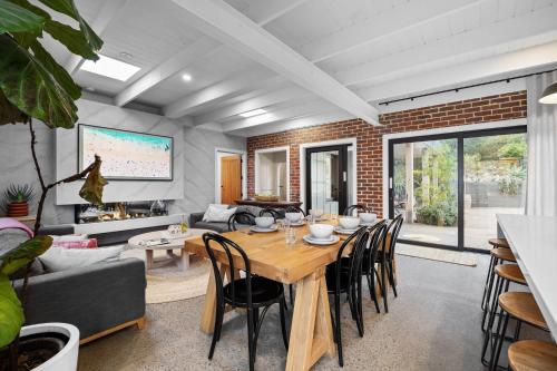 a living room with a wooden table and chairs at Sorrento Beach House in Sorrento