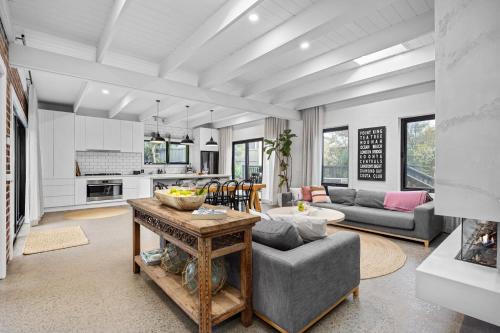 a living room with a couch and a table at Sorrento Beach House in Sorrento