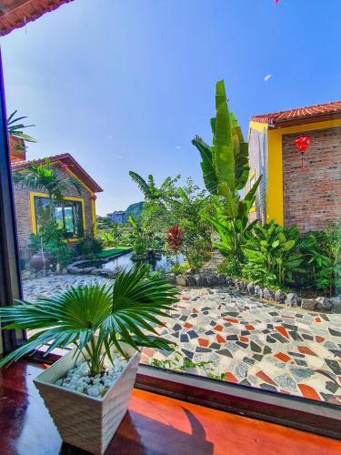 a view of a garden from the window of a house at Ninh Binh Royal Homestay in Ninh Binh