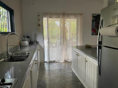 a kitchen with a sink and a window at La Belle Créole in Las Galeras