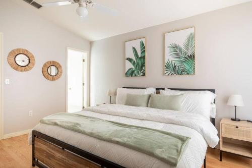 a bedroom with a large bed with two pictures on the wall at Quiet Getaway to Tampa & Orlando in Mulberry