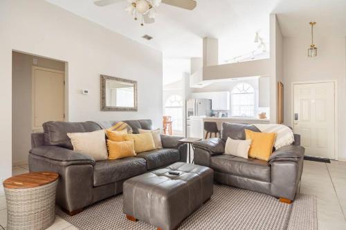 a living room with a leather couch and a table at Quiet Getaway to Tampa & Orlando in Mulberry