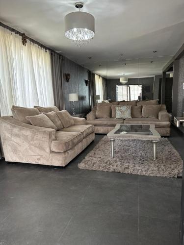 a living room with two couches and a coffee table at Residencia en Apodaca Nuevo León in Monterrey