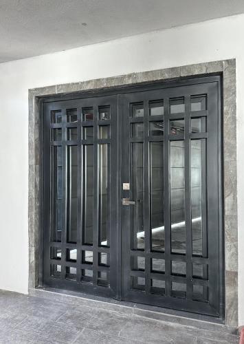 a pair of black doors on a building at Residencia en Apodaca Nuevo León in Monterrey