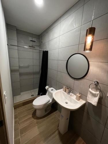W łazience znajduje się toaleta, umywalka i lustro. w obiekcie Habitación Cerezo en Palmerola, Comayagua w mieście Comayagua