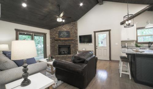 a living room with a couch and a fireplace at NEW! Murphy*Hot Tub*Fire Pit in Murphy