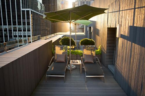 a row of chairs and an umbrella on a balcony at Shoreham Hotel in New York