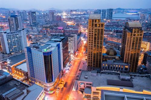 a view of a city at night with buildings at Holiday Inn Express City Centre Dalian by IHG in Dalian