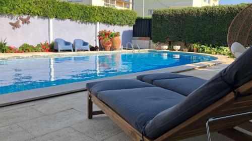 a swimming pool with two chaise lounges in front at MAR VERDE - Parede-Cascais in Parede