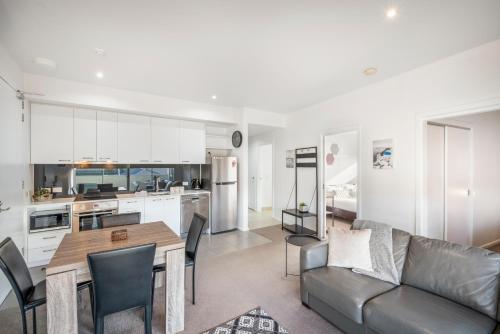 a kitchen and living room with a couch and a table at Bellerive Quay - 2 Bedroom Apartment - Free Parking - Free WIFI in Bellerive
