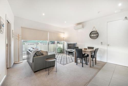 a living room with a couch and a table at Bellerive Quay - 2 Bedroom Apartment - Free Parking - Free WIFI in Bellerive