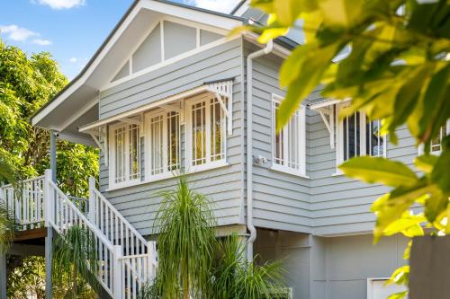 a white house with white railings and windows at Dicky Beach Original - 2 Bed Downstairs Studio 200m to Beach in Caloundra