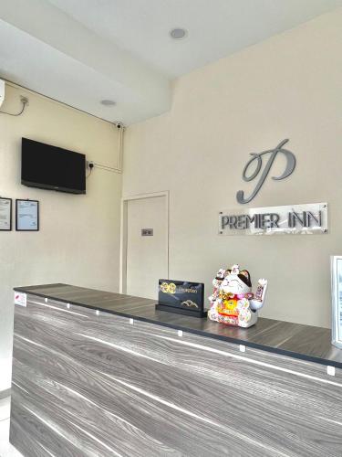 a baggage claim at an airport with a sign on the wall at Hotel Premier Inn (Prima Square) in Sandakan