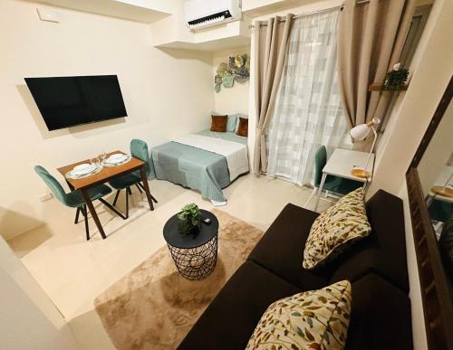 a living room with a couch and a table at Lengs Place 2 - Studio Unit with Balcony at Inspiria Condo in Davao City