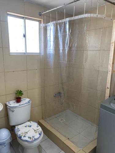 a bathroom with a shower with a toilet and a tub at Casa de Campo in Santa Cruz