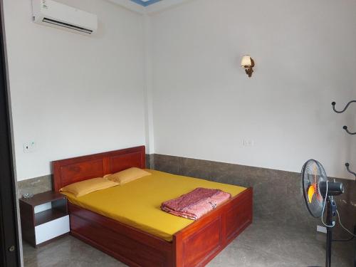 Un dormitorio con una cama con una manta amarilla. en Hotel Như Nguyệt, en Việt Yên