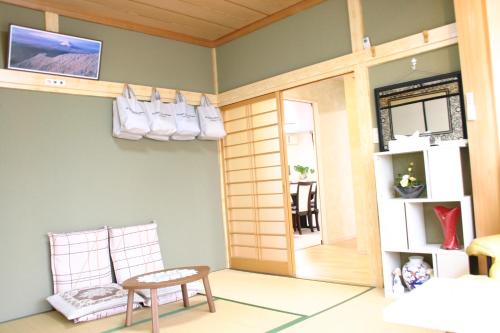 a room with a door and a chair and a table at 山中湖リゾートハウス in Yamanakako
